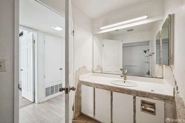 a bathroom with a double vanity sink mirror and