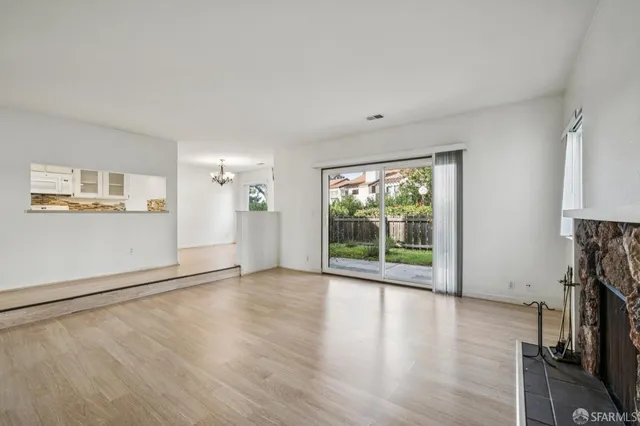 a view of a livingroom with wooden floor and a window