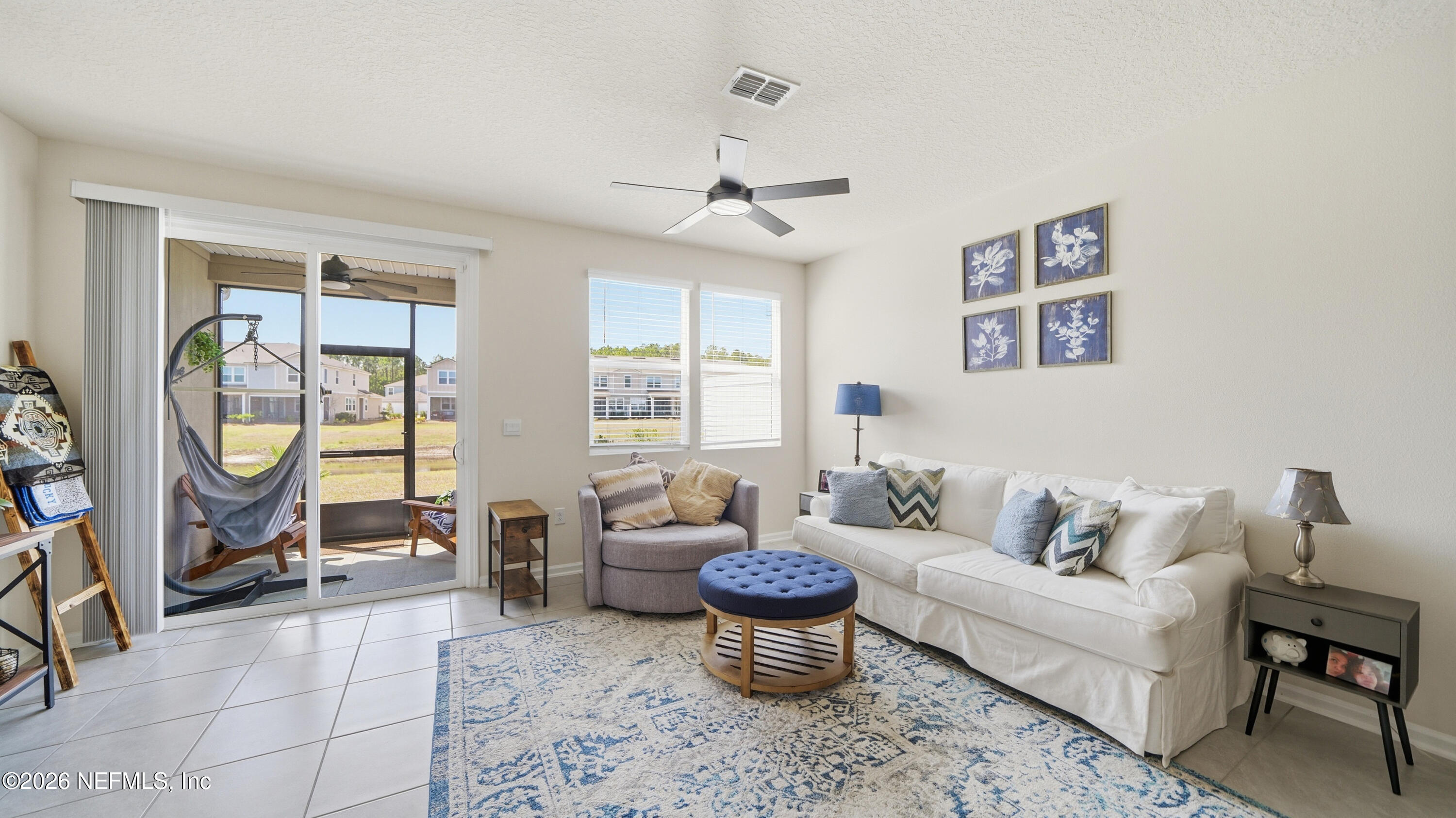 172 Redbud Road Palm Coast, FL 32137 - Photo 11 of 43 a living room with furniture a chandelier and a window