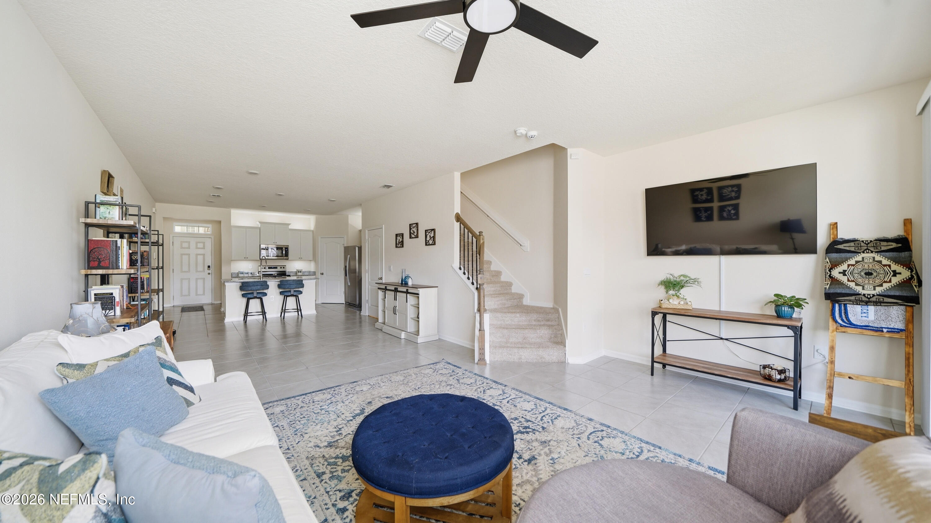 172 Redbud Road Palm Coast, FL 32137 - Photo 12 of 43 a living room with furniture and a flat screen tv