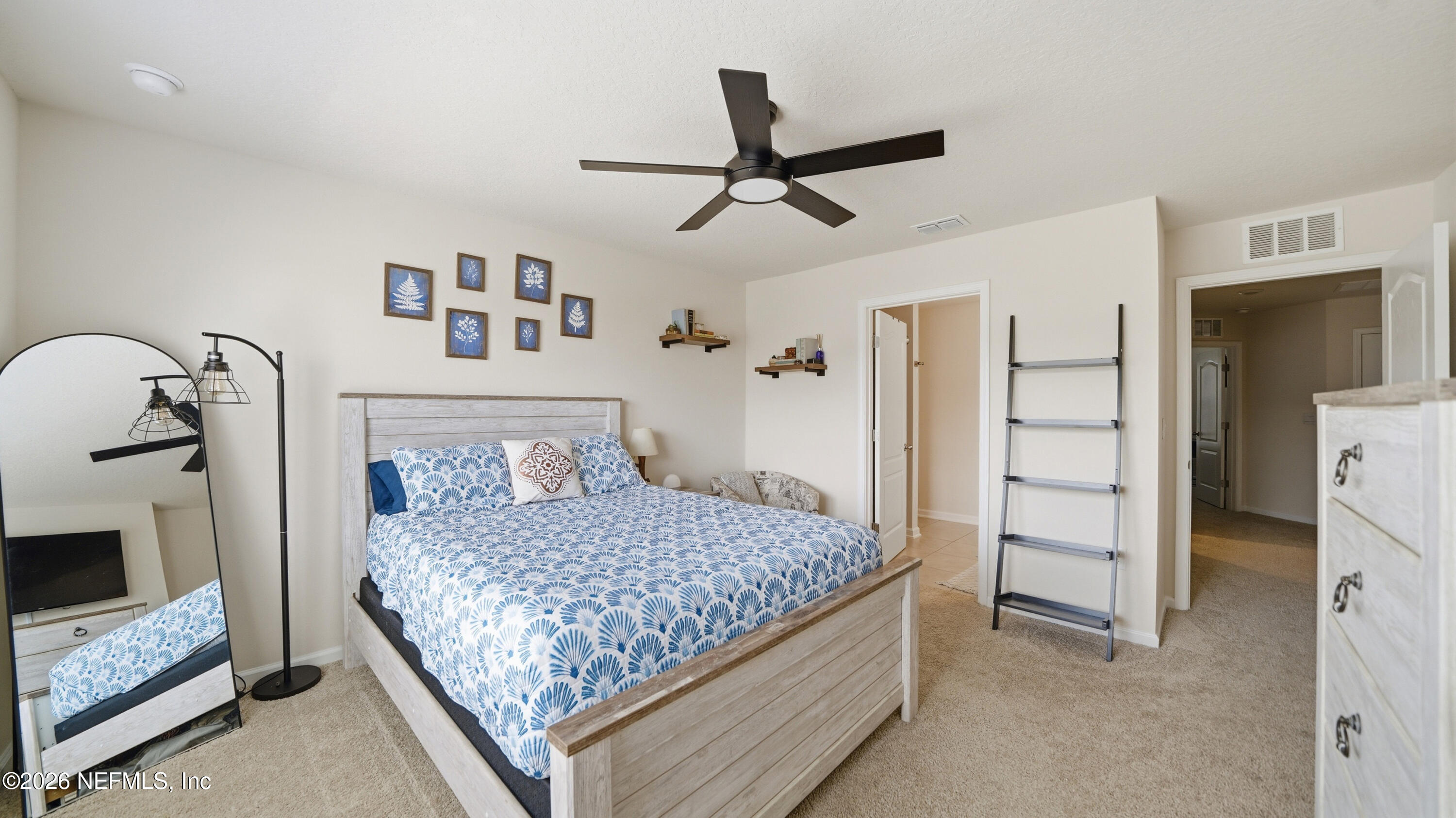 172 Redbud Road Palm Coast, FL 32137 - Photo 20 of 43 a bedroom with a bed and a mirror