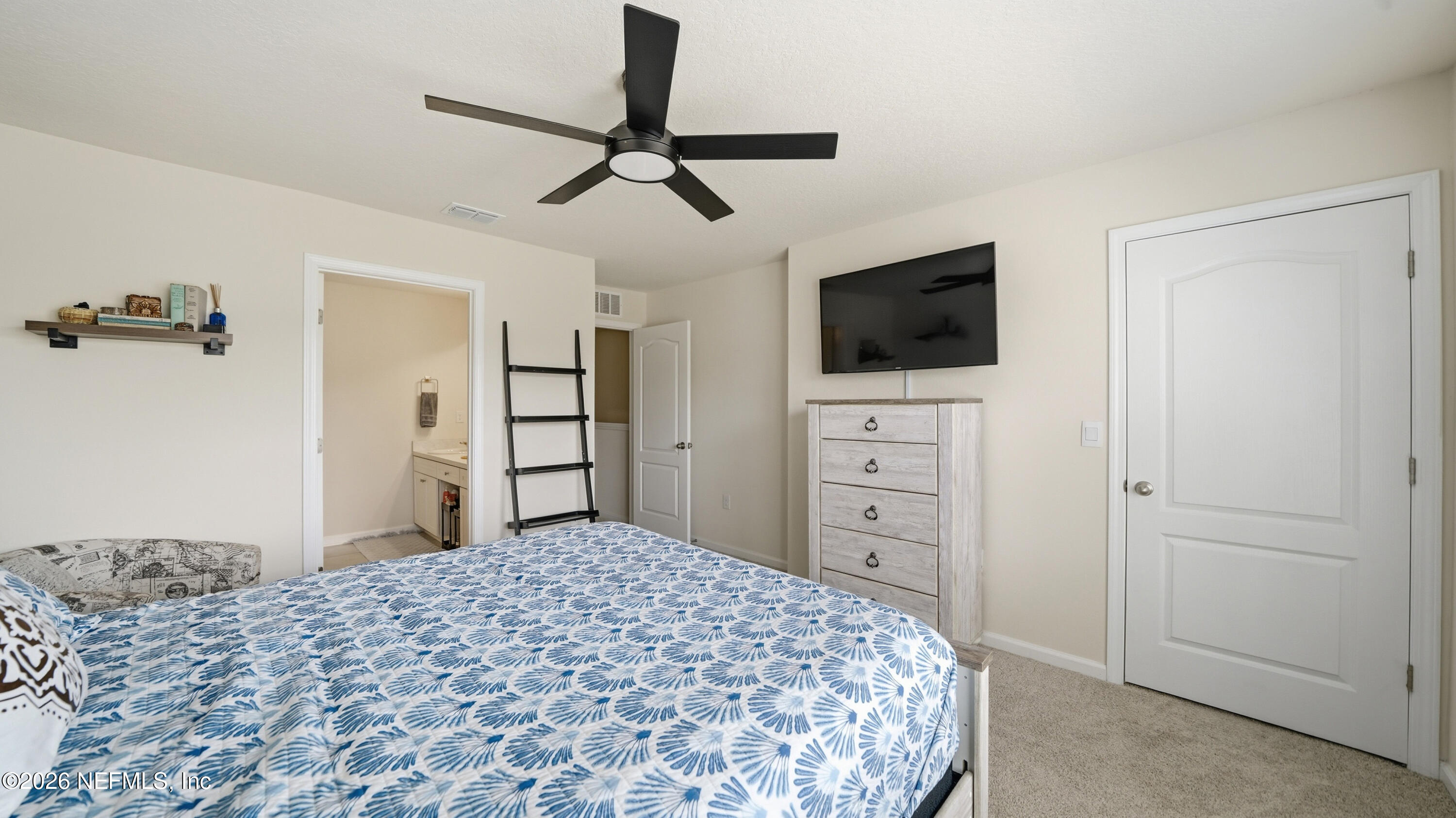 172 Redbud Road Palm Coast, FL 32137 - Photo 21 of 43 a bedroom with a bed and a flat screen tv