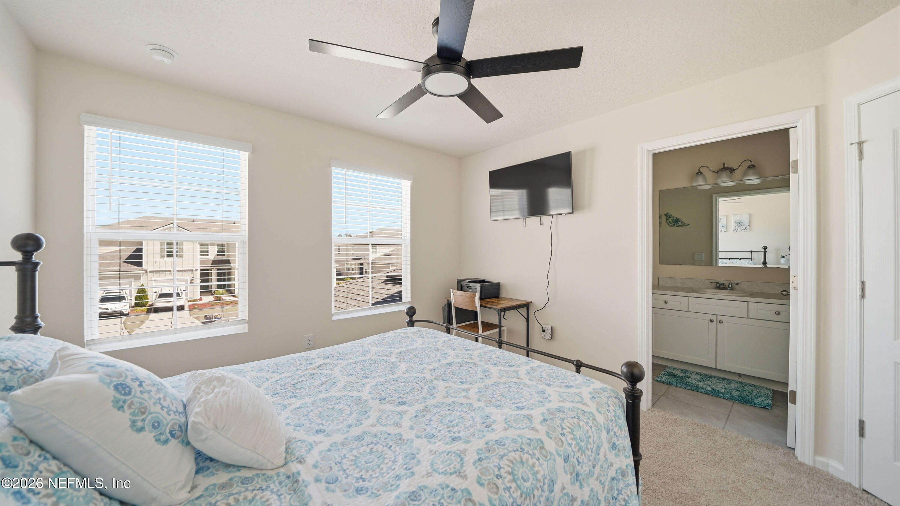 172 Redbud Road Palm Coast, FL 32137 - Photo 27 of 43 a bedroom with a bed a chair and next to a window