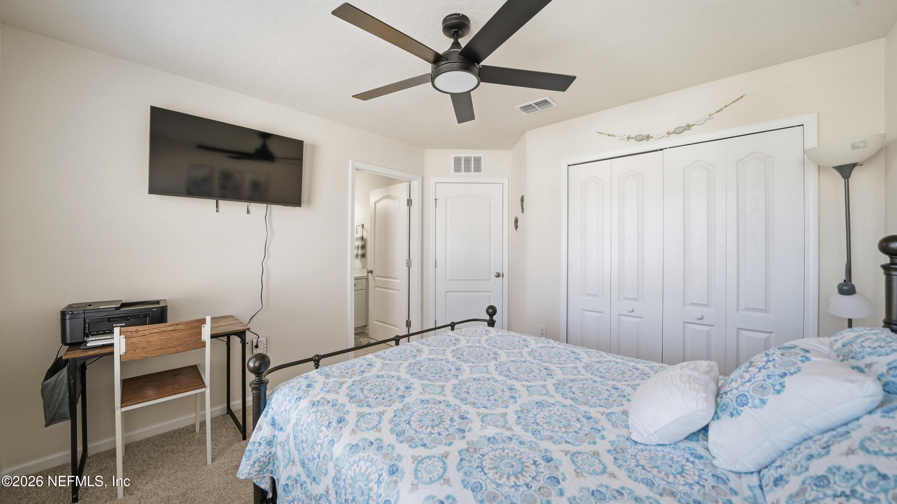 172 Redbud Road Palm Coast, FL 32137 - Photo 28 of 43 a bedroom with a bed and a flat screen tv