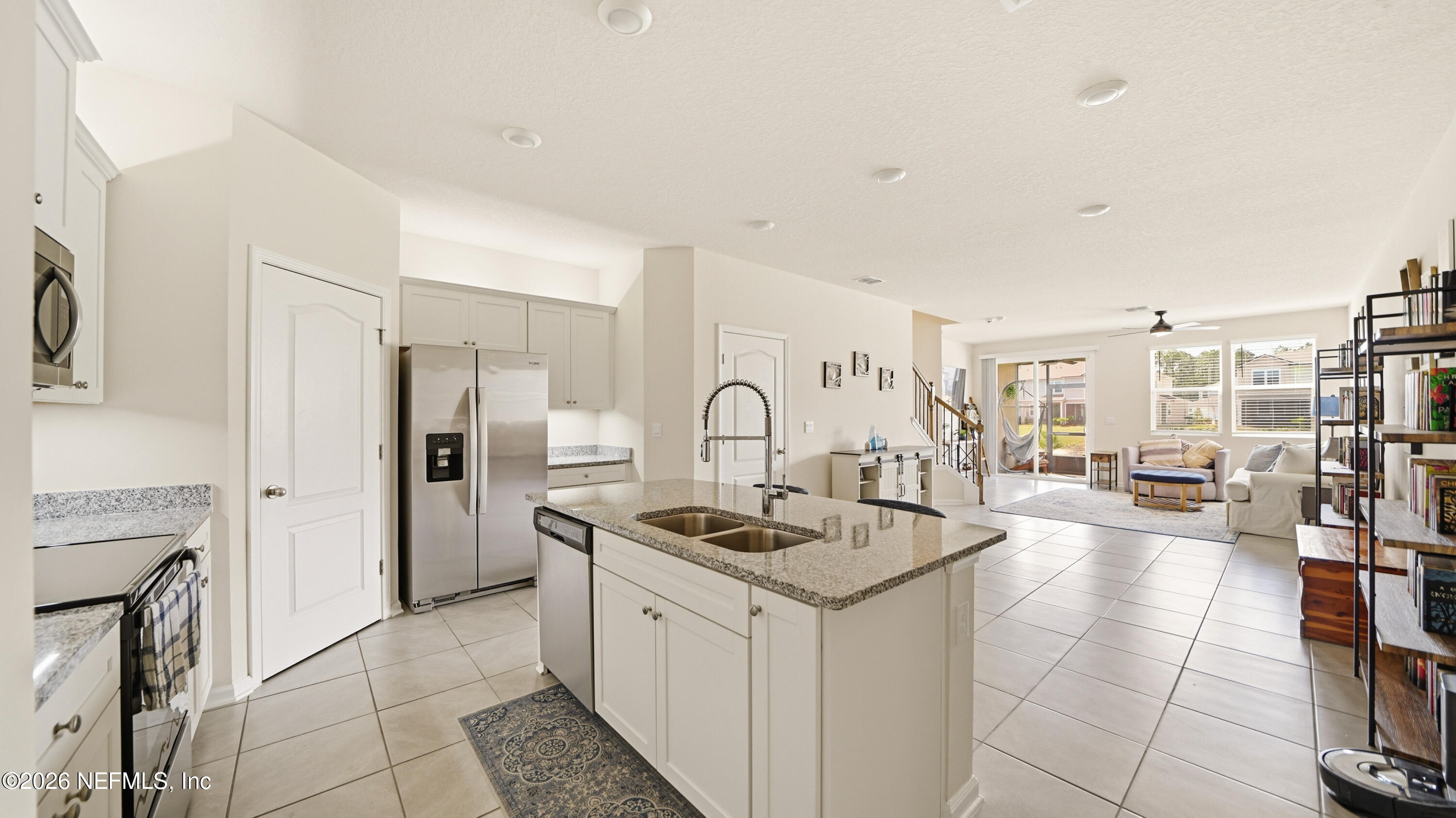 172 Redbud Road Palm Coast, FL 32137 - Photo 3 of 43 a kitchen with a refrigerator and a stove top oven