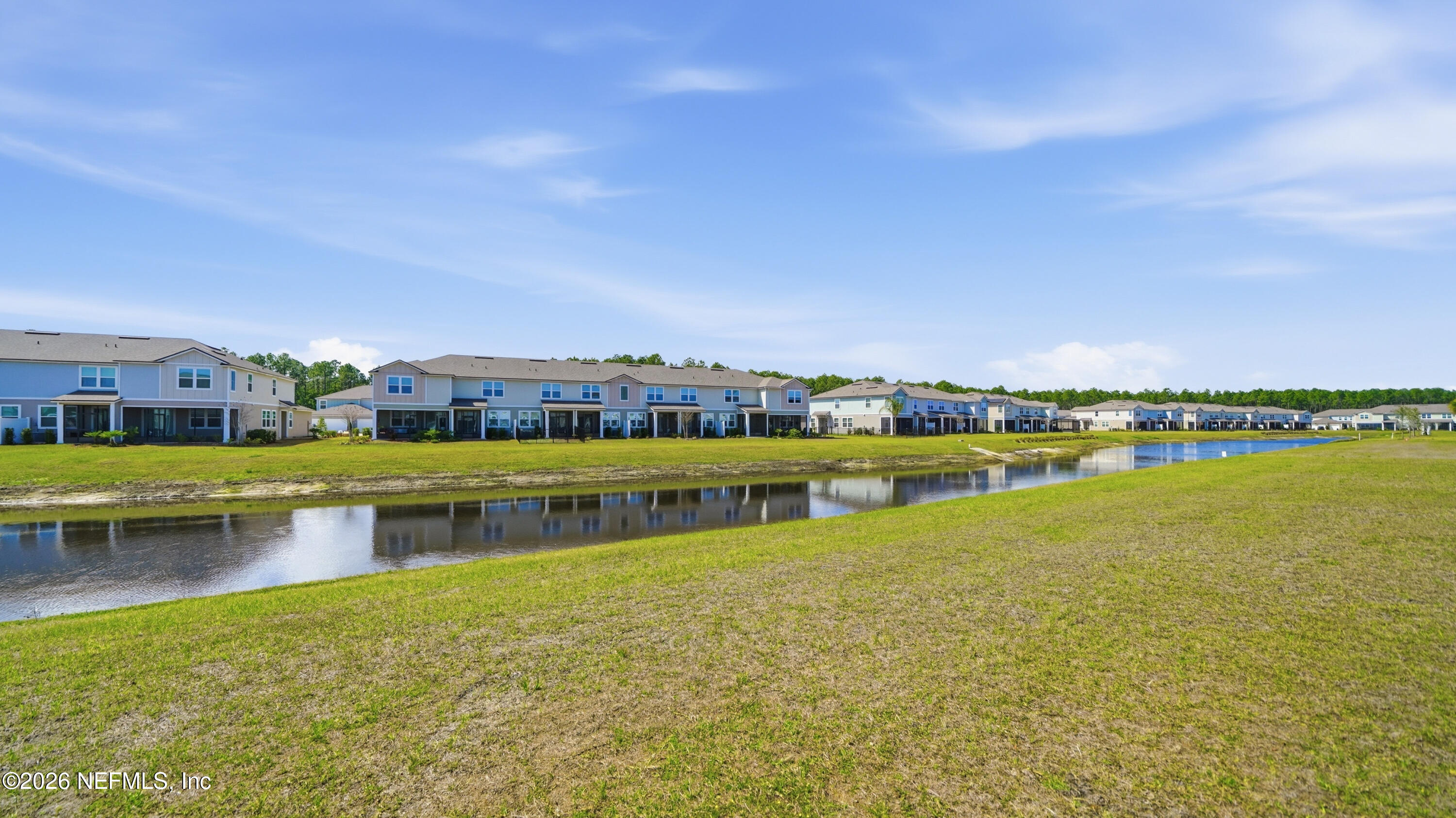 172 Redbud Road Palm Coast, FL 32137 - Photo 32 of 43 a view of a lake with houses in the background