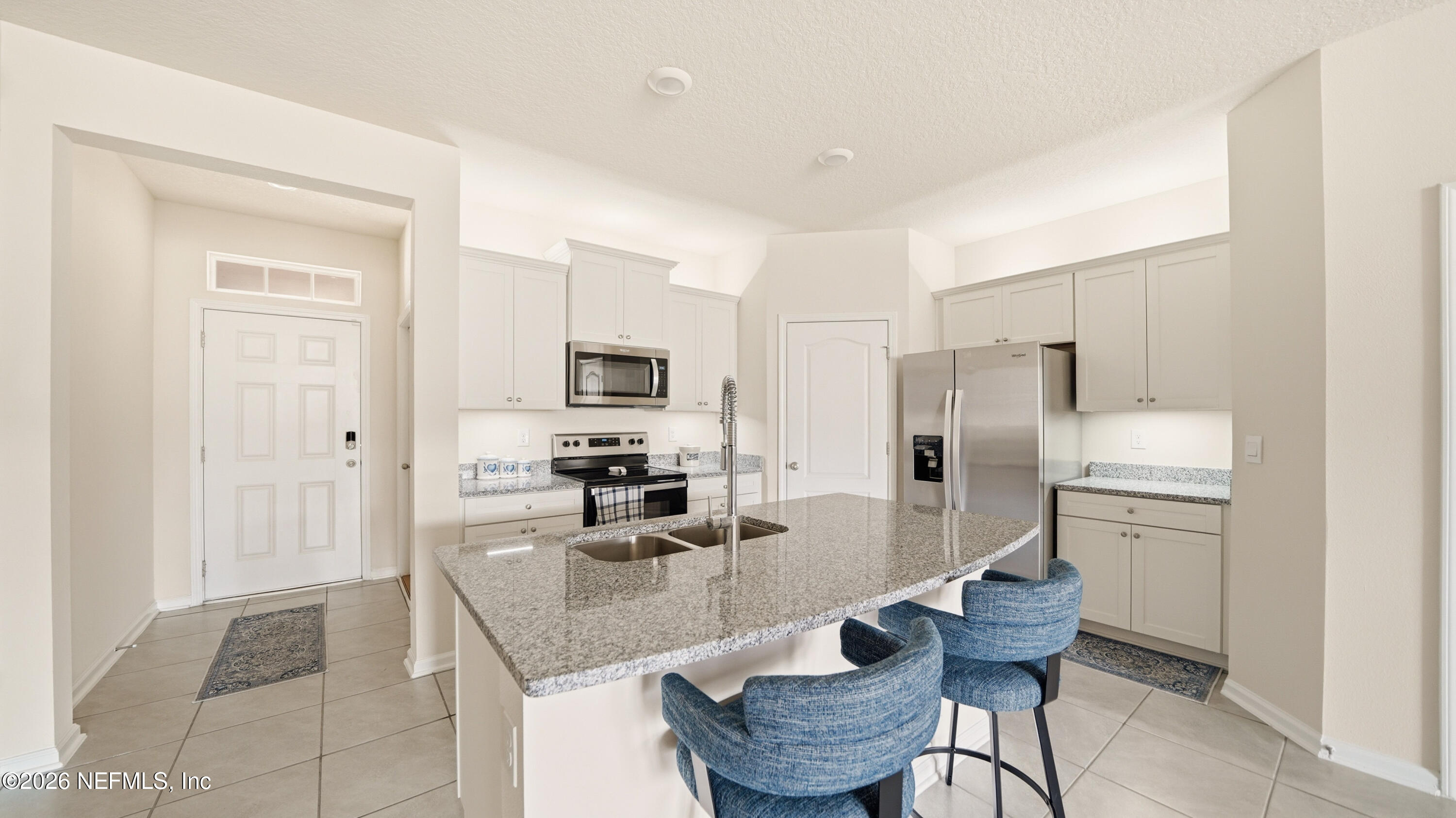 172 Redbud Road Palm Coast, FL 32137 - Photo 4 of 43 a kitchen with refrigerator and cabinets