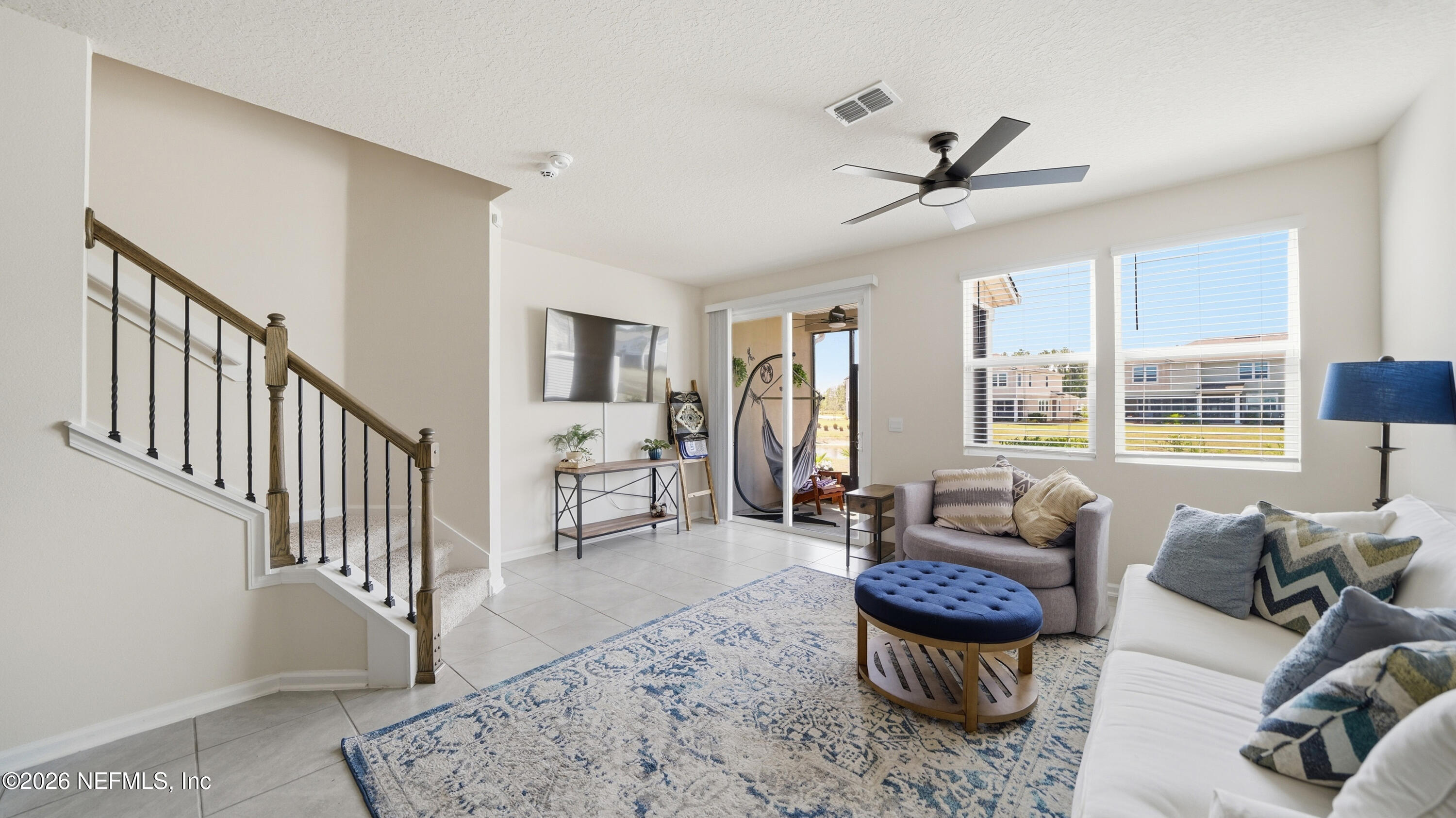 172 Redbud Road Palm Coast, FL 32137 - Photo 5 of 43 a living room with furniture ceiling fan and a window