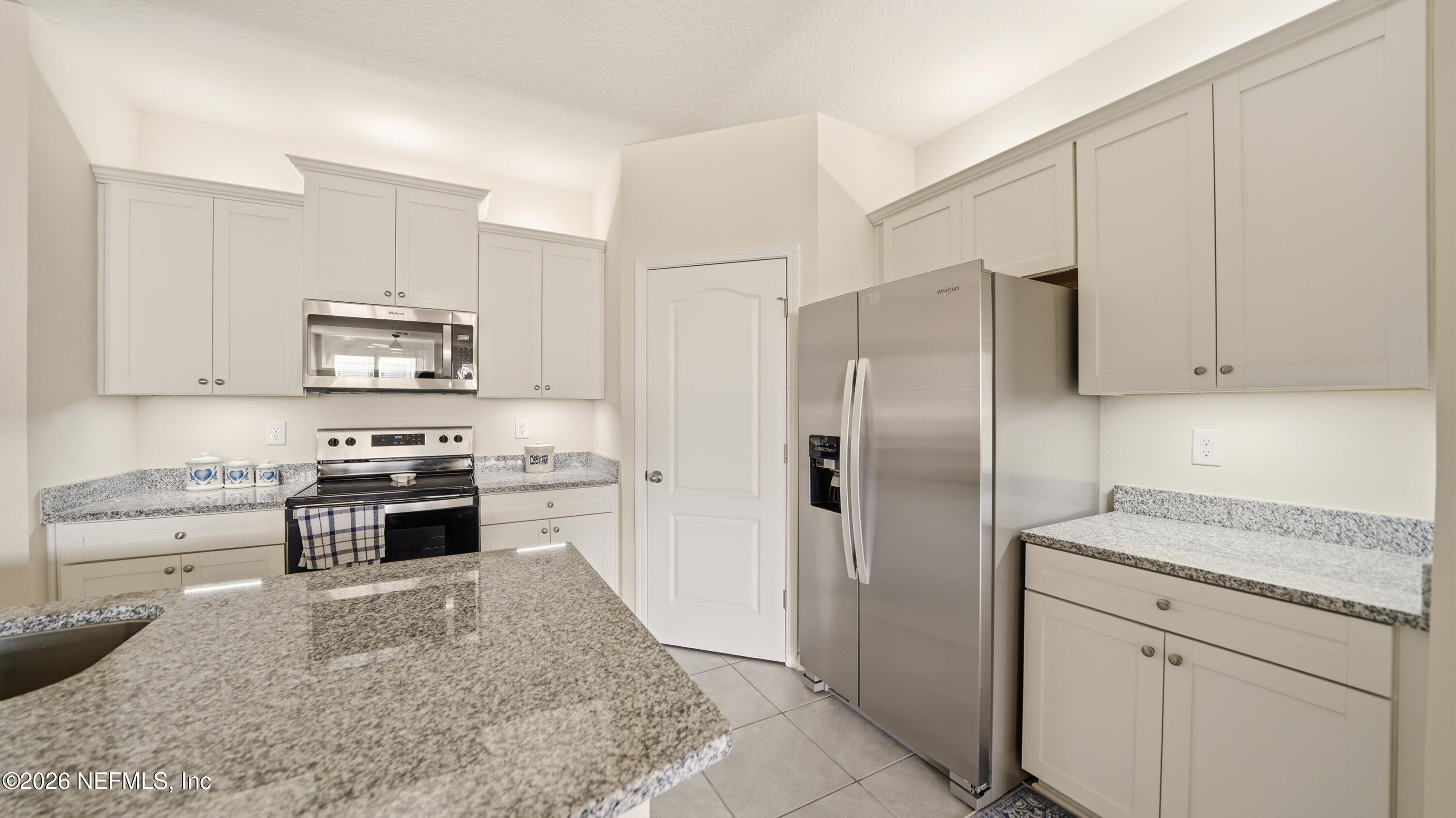 172 Redbud Road Palm Coast, FL 32137 - Photo 6 of 43 a kitchen with a refrigerator stove and sink