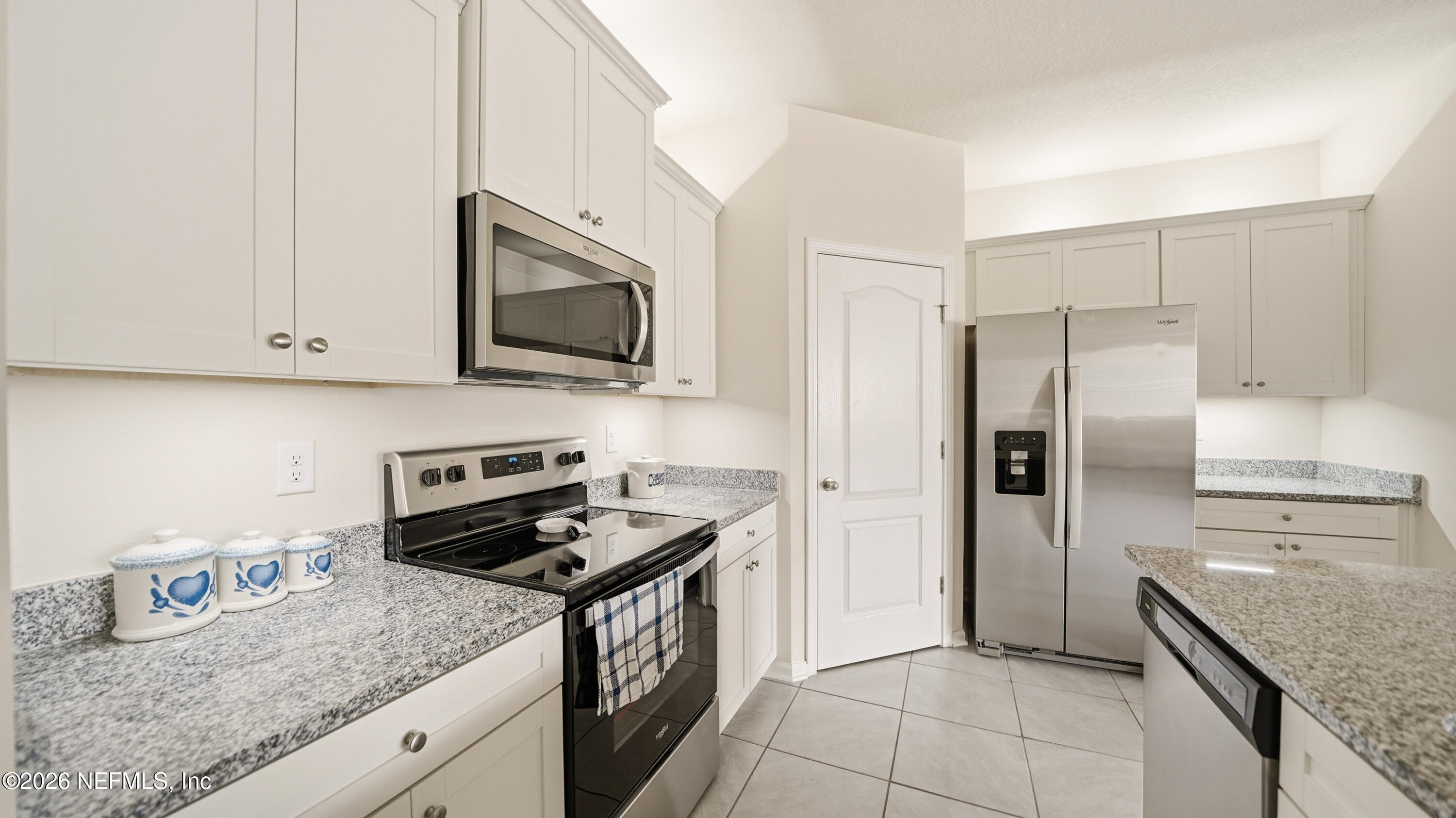 172 Redbud Road Palm Coast, FL 32137 - Photo 8 of 43 a kitchen with granite countertop a sink stove and refrigerator