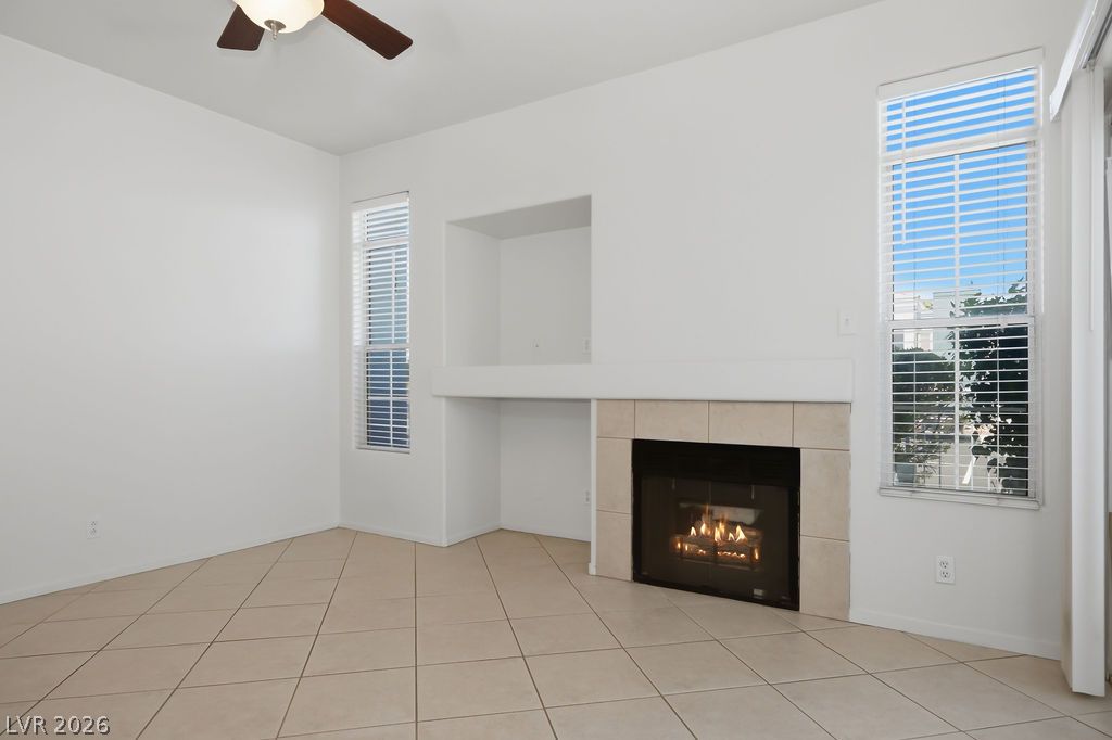 A well-lit living area features a charming fireplace, perfect for cozy evenings.
