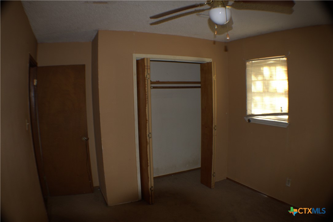 206 Meadowbrook Street Dale, TX 78616 - Photo 7 of 10 an empty room with windows and closet
