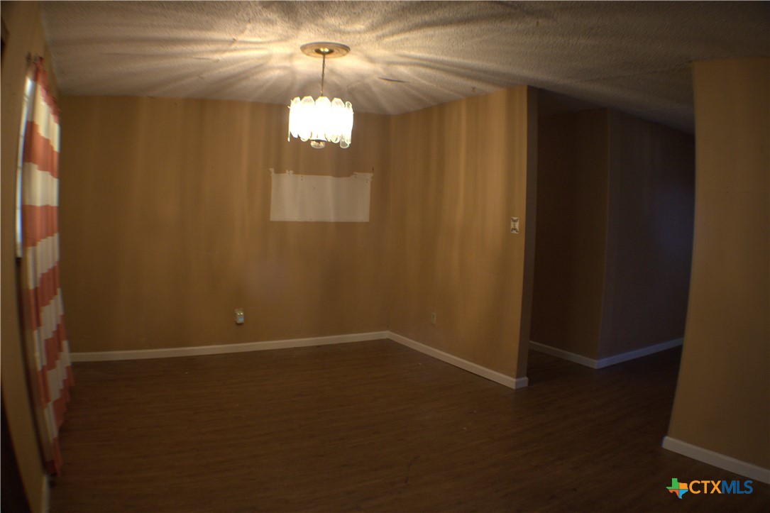 206 Meadowbrook Street Dale, TX 78616 - Photo 9 of 10 an empty room with windows and entrance