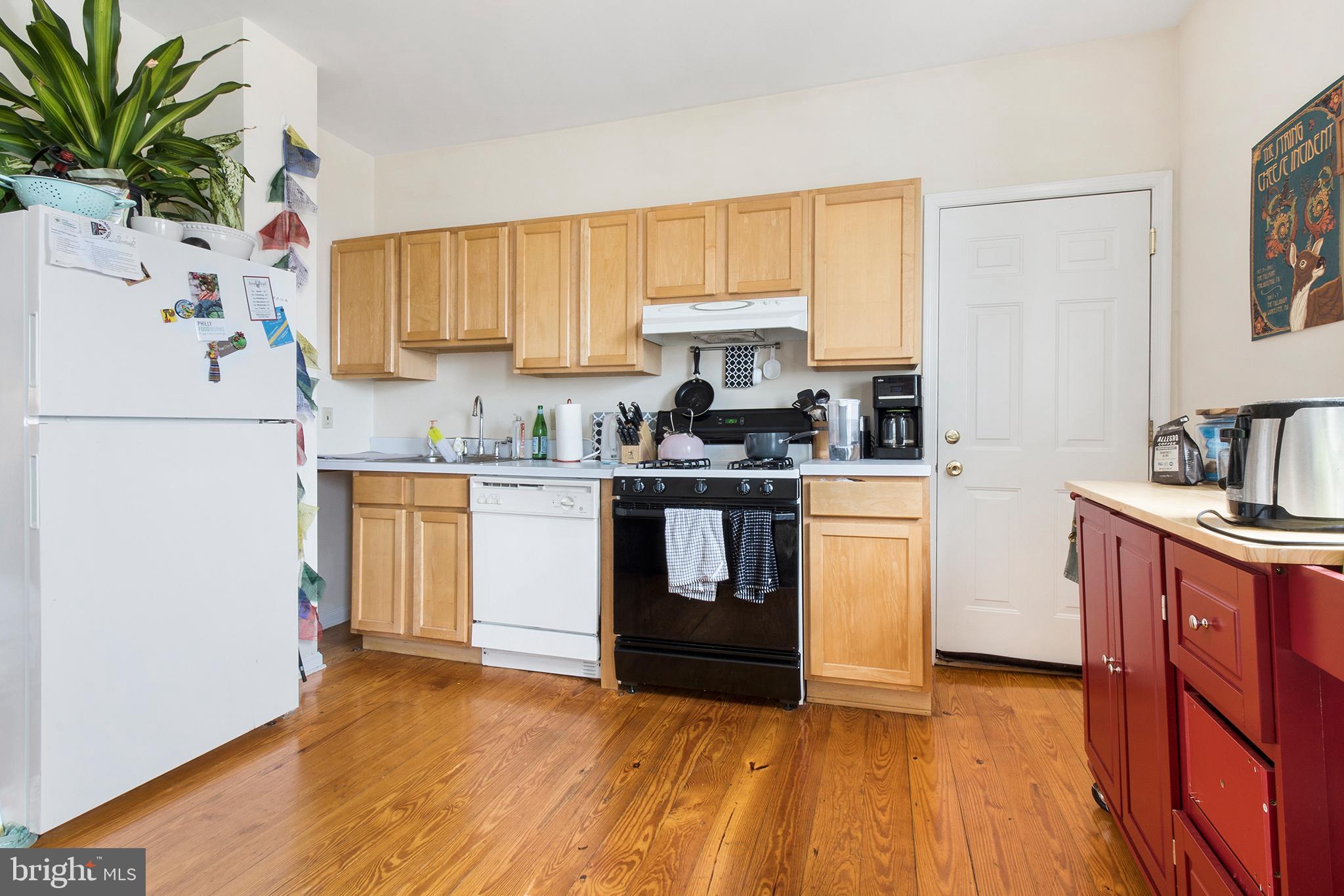 321-23 North Front Street, Unit 4 Philadelphia, PA 19106 - Photo 5 of 15 a kitchen with a white stove top oven sink and cabinets