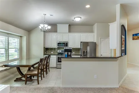 a dining room with furniture and chandelier