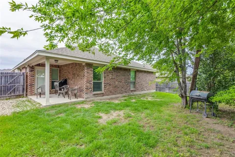 a front view of a house with patio and garden