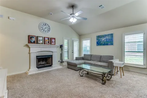 a living room with furniture and kitchen view