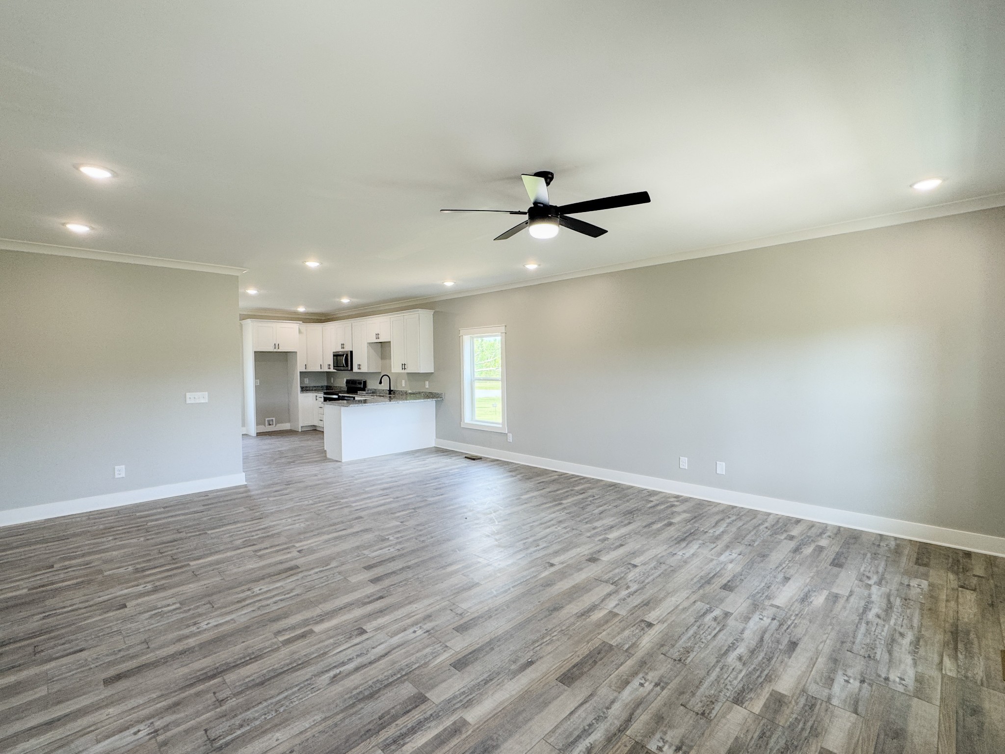 181 Rock House Hollow Road Bethpage, TN 37022 - Photo 12 of 51 an empty room with wooden floor and windows