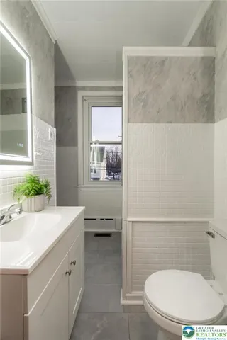 a bath room with a sink and a bath tub