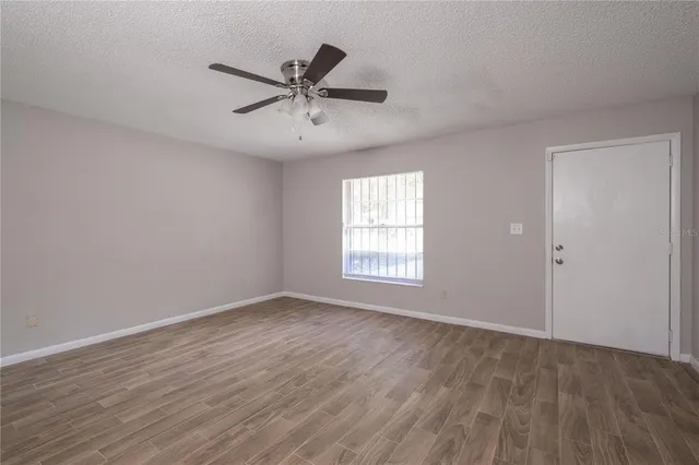 a view of a big room with wooden floor closet and windows