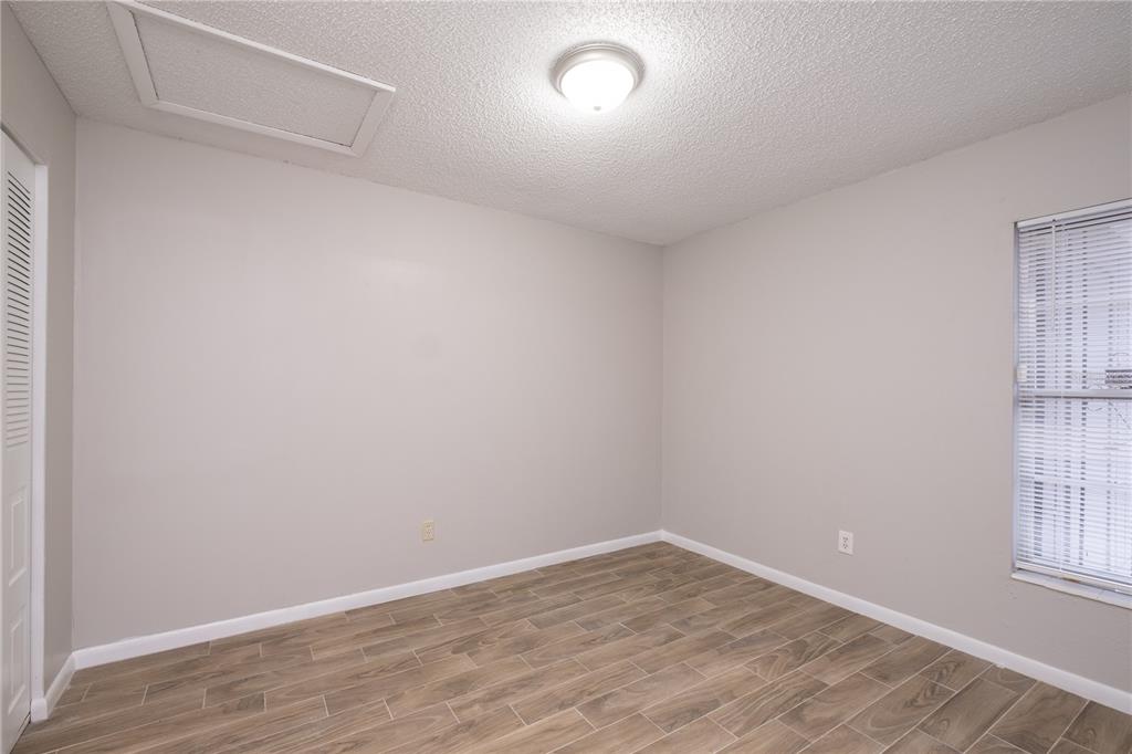 6216 Southwest 10th Place, Unit B Gainesville, FL 32607 - Photo 18 of 24 wooden floor in an empty room with a window