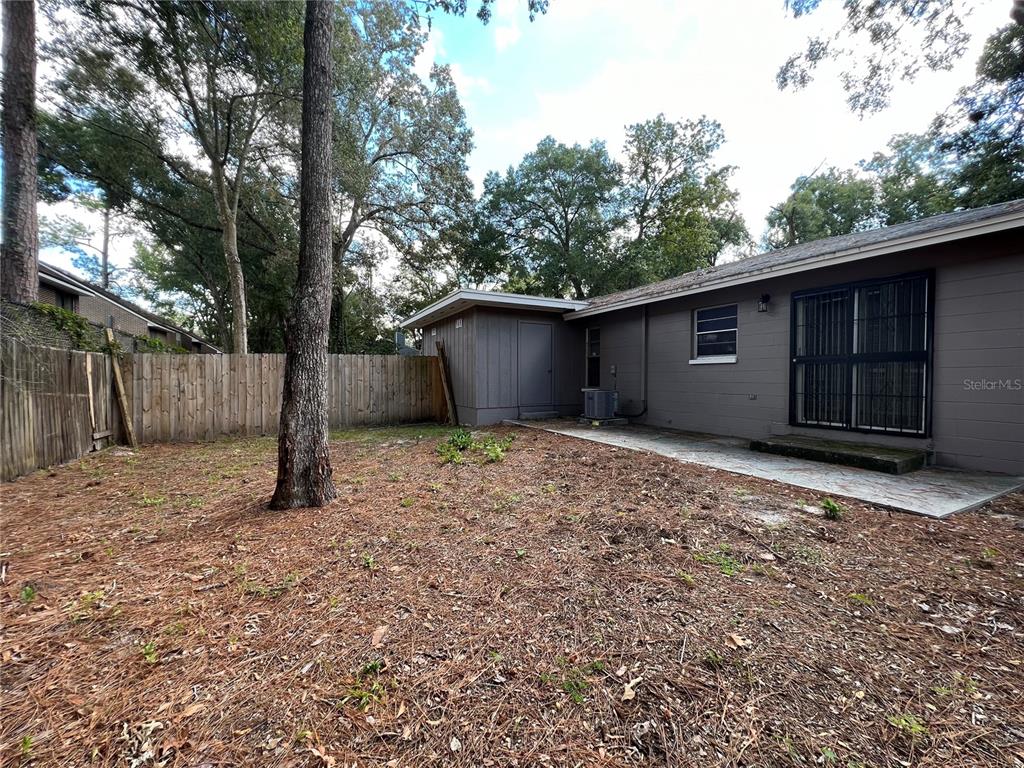 6216 Southwest 10th Place, Unit B Gainesville, FL 32607 - Photo 21 of 24 a backyard of a house with lots of green space