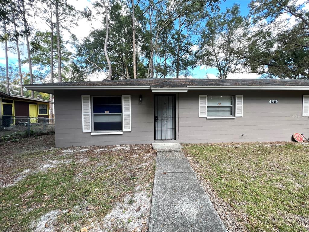 6216 Southwest 10th Place, Unit B Gainesville, FL 32607 - Photo 8 of 24 a front view of a house with a garden