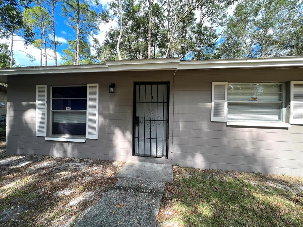 6216 Southwest 10th Place, Unit B Gainesville, FL 32607 - Photo 9 of 24 a front view of a house with a yard