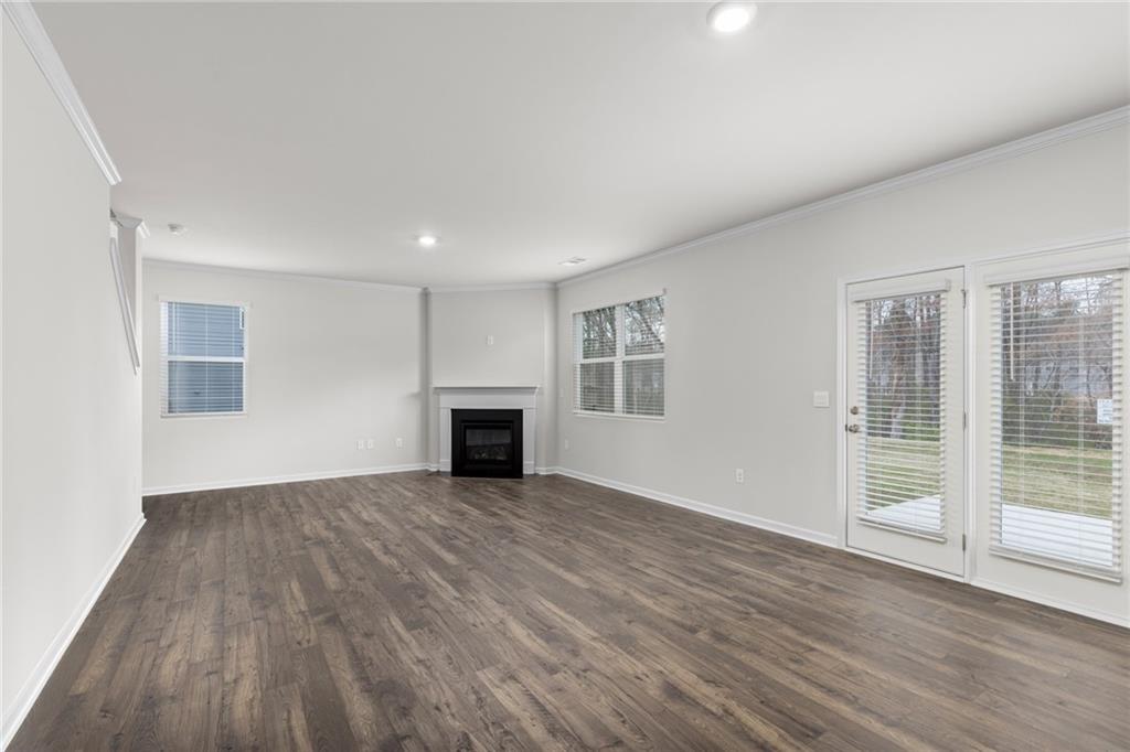 5370 Swan Lane Powder Springs, GA 30127 - Photo 13 of 54 a view of empty room with wooden floor and fireplace