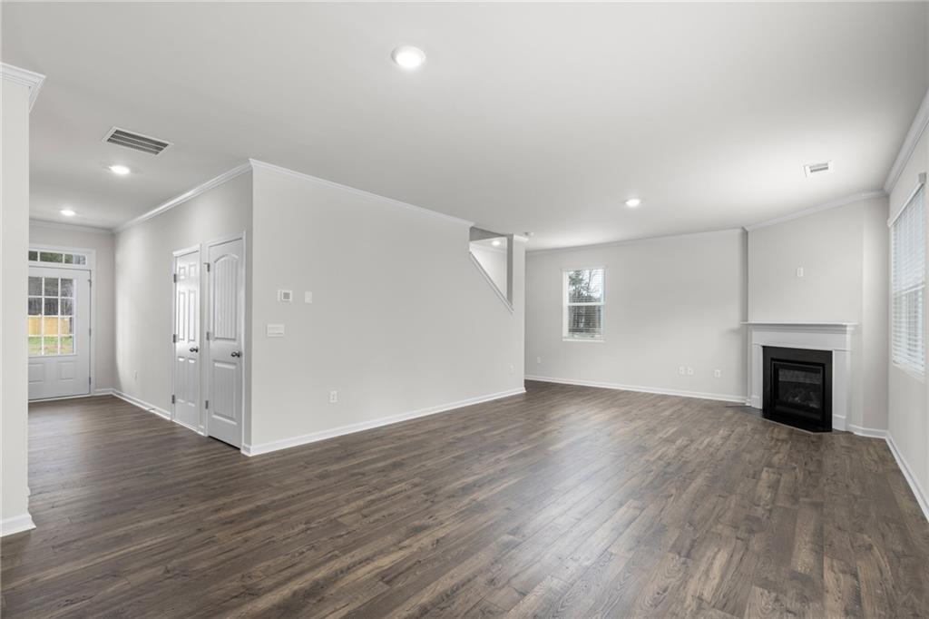 5370 Swan Lane Powder Springs, GA 30127 - Photo 14 of 54 an empty room with wooden floor fireplace and windows