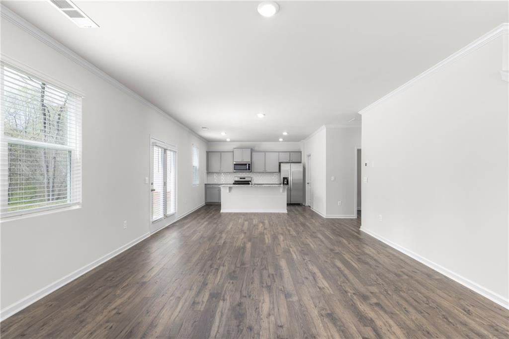 5370 Swan Lane Powder Springs, GA 30127 - Photo 16 of 54 a view of a kitchen with wooden floor and a window