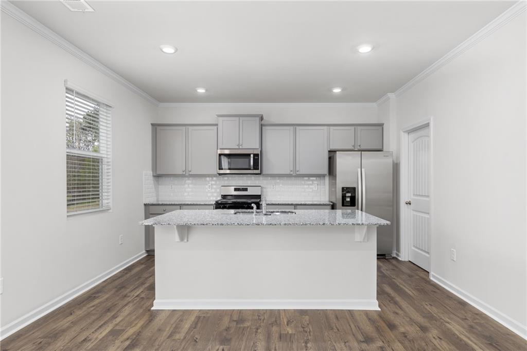 5370 Swan Lane Powder Springs, GA 30127 - Photo 2 of 54 a kitchen with stainless steel appliances a white stove top oven sink and cabinets