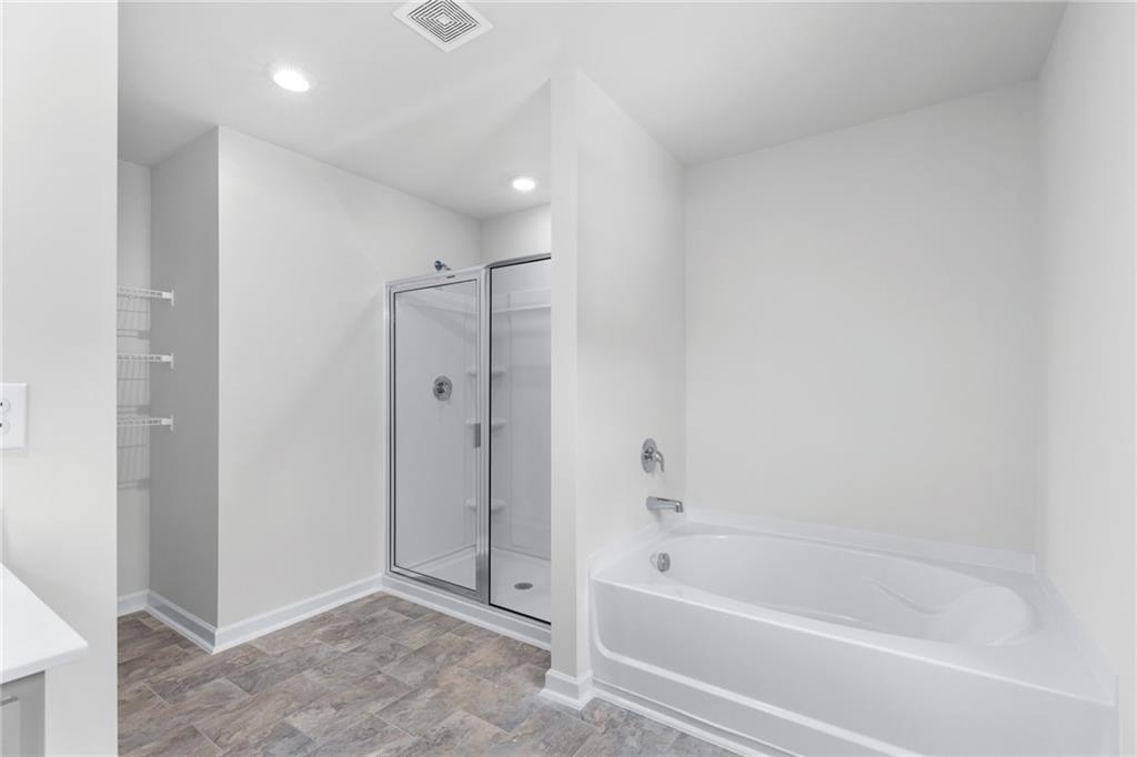 5370 Swan Lane Powder Springs, GA 30127 - Photo 24 of 54 a bathroom with a bathtub and a shower