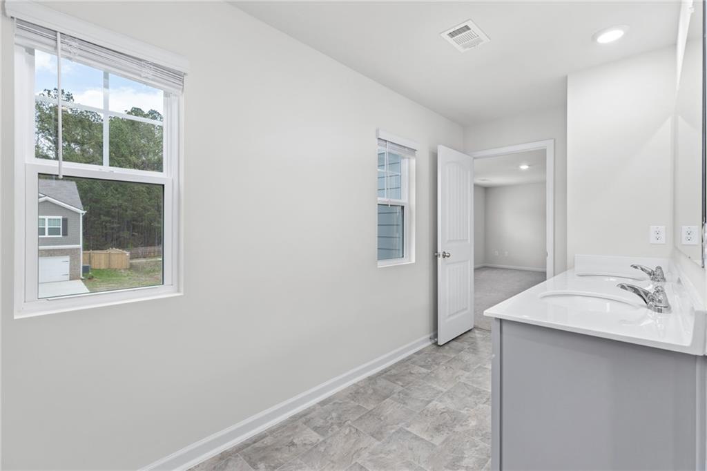 5370 Swan Lane Powder Springs, GA 30127 - Photo 25 of 54 a bathroom with a sink and a mirror