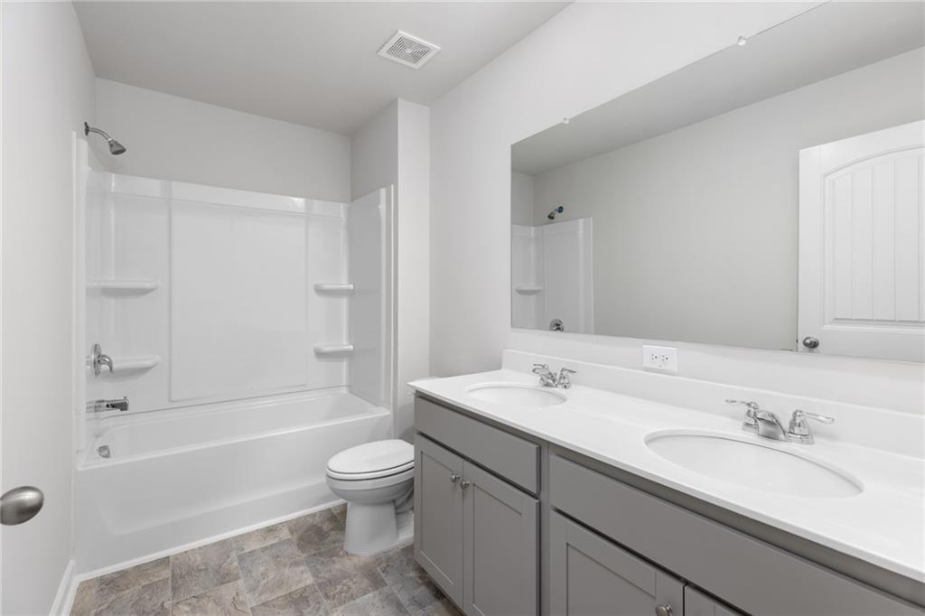 5370 Swan Lane Powder Springs, GA 30127 - Photo 35 of 54 a bathroom with a sink a toilet and shower
