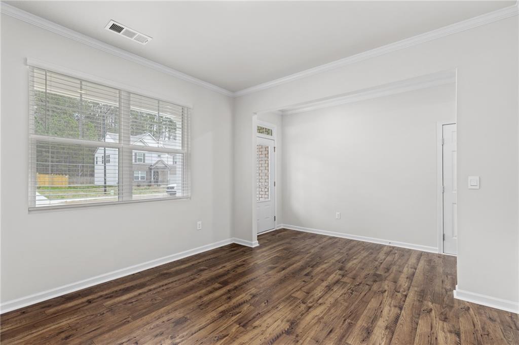 5370 Swan Lane Powder Springs, GA 30127 - Photo 8 of 54 a view of an empty room with wooden floor and a window