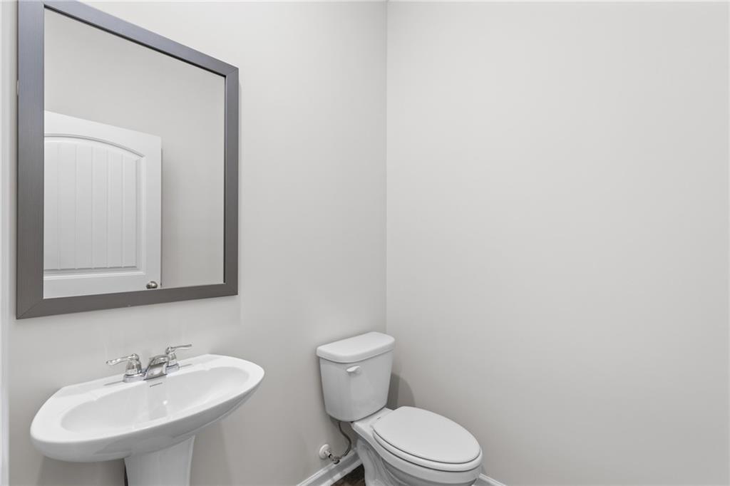 5370 Swan Lane Powder Springs, GA 30127 - Photo 9 of 54 a bathroom with a toilet a sink and mirror