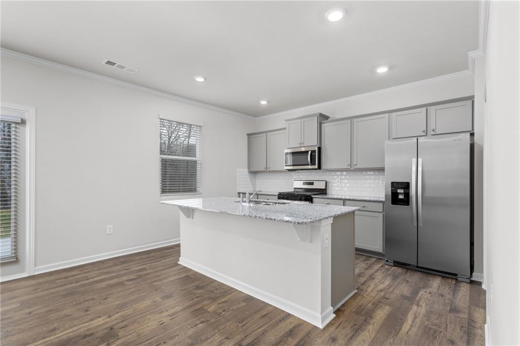 5370 Swan Lane Powder Springs, GA 30127 - Photo 10 of 54 a kitchen with stainless steel appliances a sink stove refrigerator and cabinets