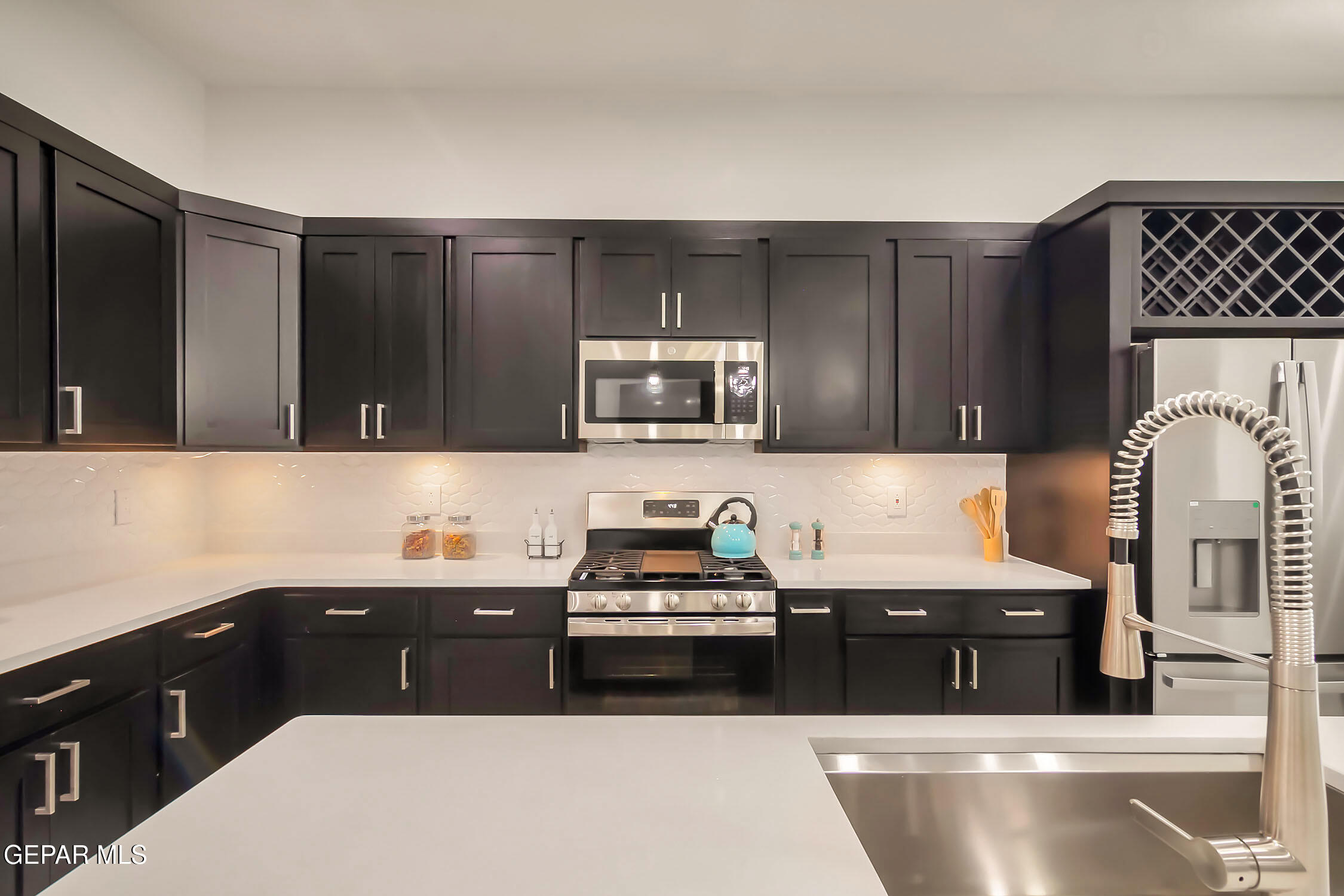 3853 Object Place El Paso, TX 79938 - Photo 19 of 31 a kitchen with a sink and a stove