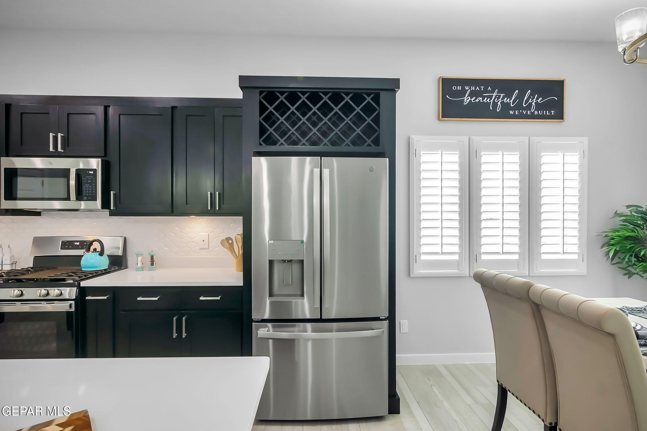 3853 Object Place El Paso, TX 79938 - Photo 20 of 31 a kitchen with granite countertop a refrigerator and a stove top oven