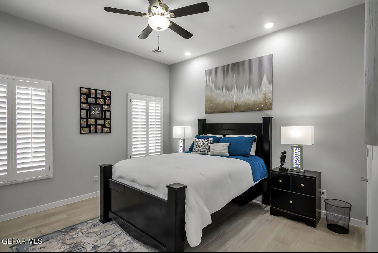 3853 Object Place El Paso, TX 79938 - Photo 2 of 31 a bedroom with a bed and a chandelier