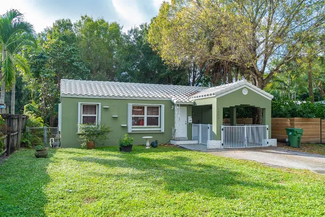 a front view of house with a garden