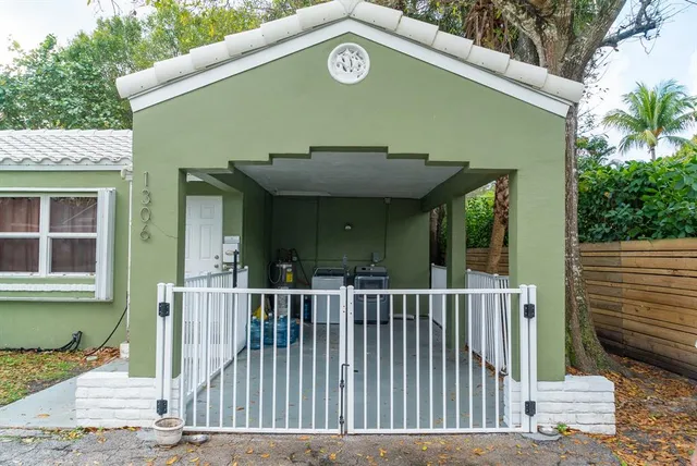 a view of a house with a small yard next to a road