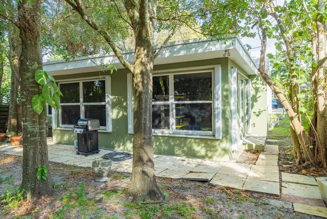 a front view of a house with outdoor seating