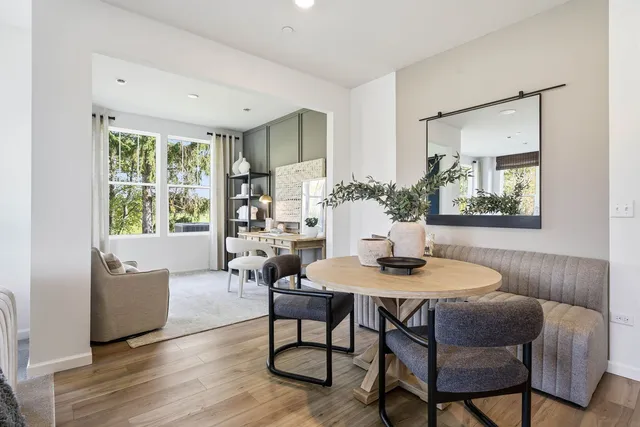 a dining room with furniture and wooden floor