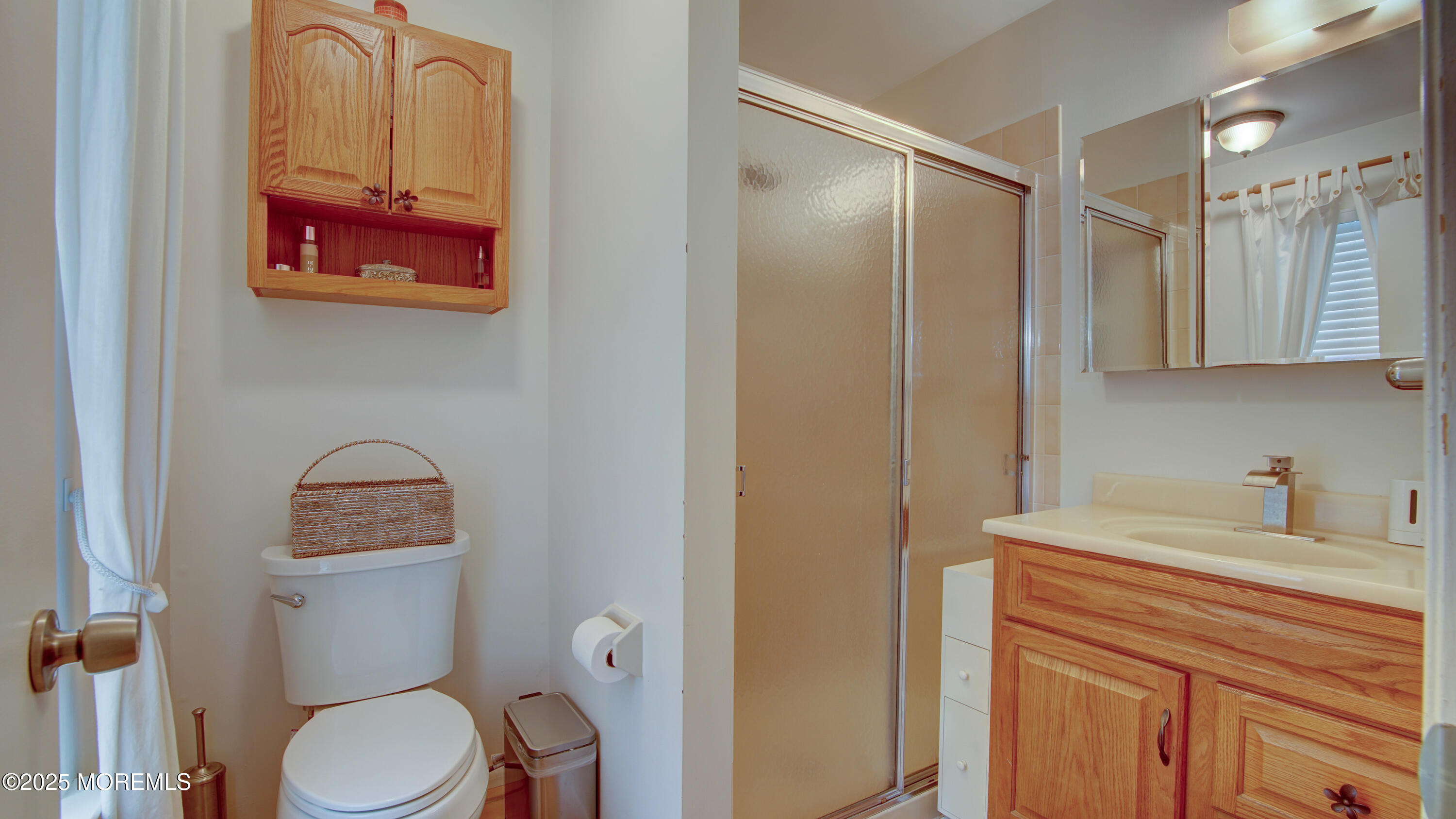 57 Chestnut Way Manalapan, NJ 07726 - Photo 15 of 23 a bathroom with a toilet a sink and mirror