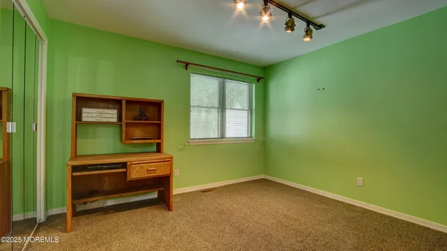 a room with a window and a dresser