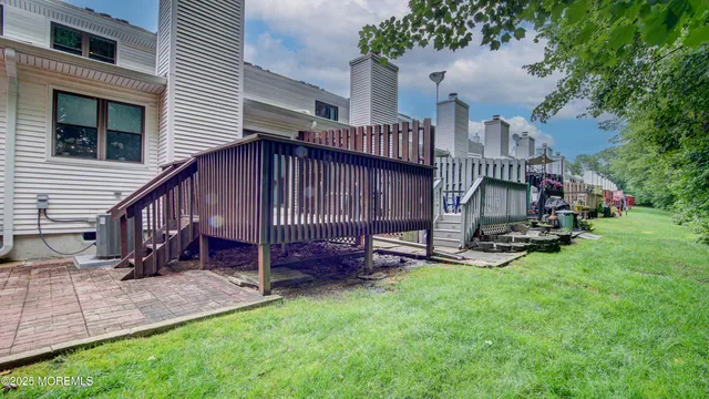 a view of backyard with deck and garden