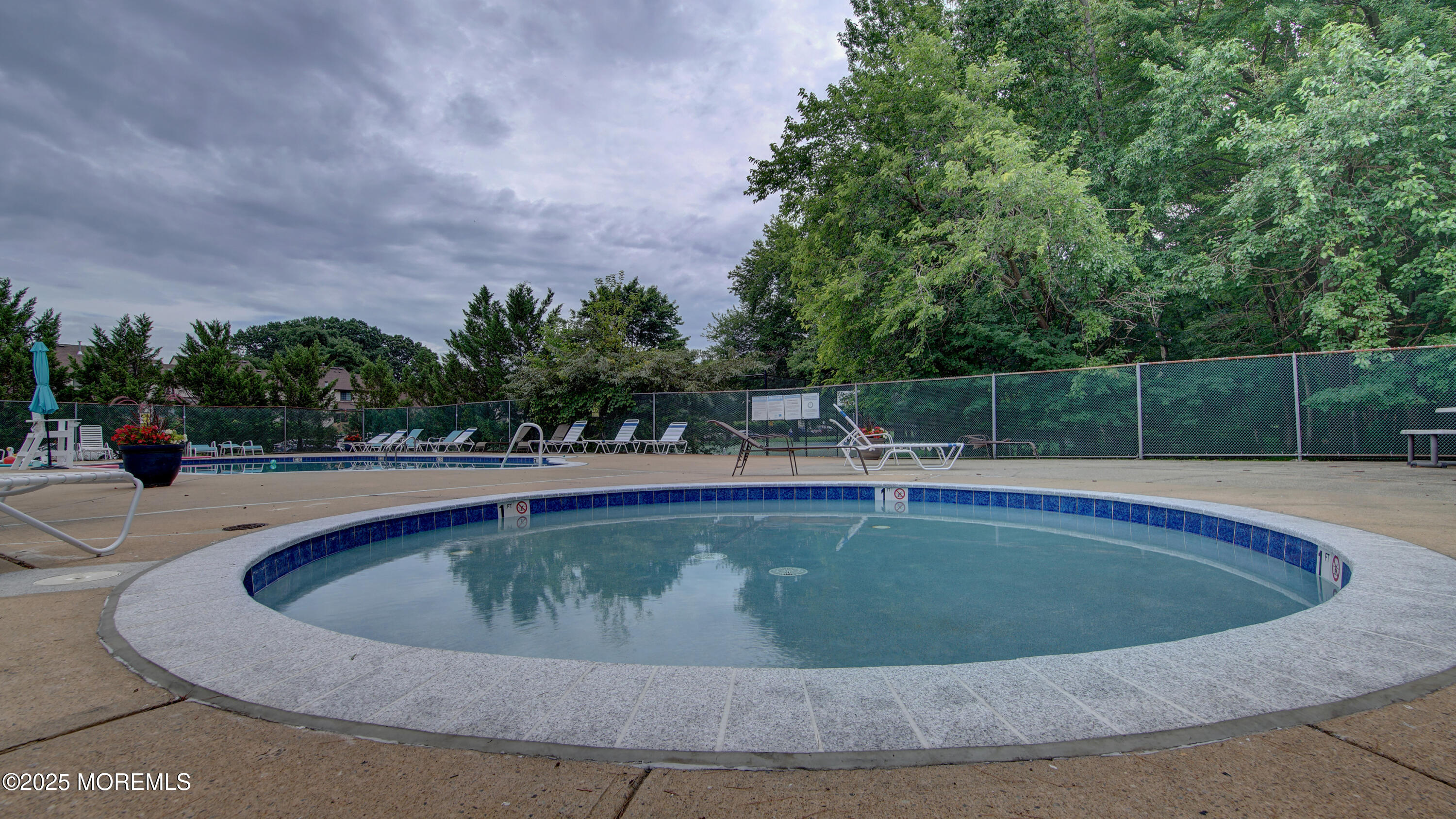 57 Chestnut Way Manalapan, NJ 07726 - Photo 21 of 23 a view of swimming pool with outdoor seating and plants