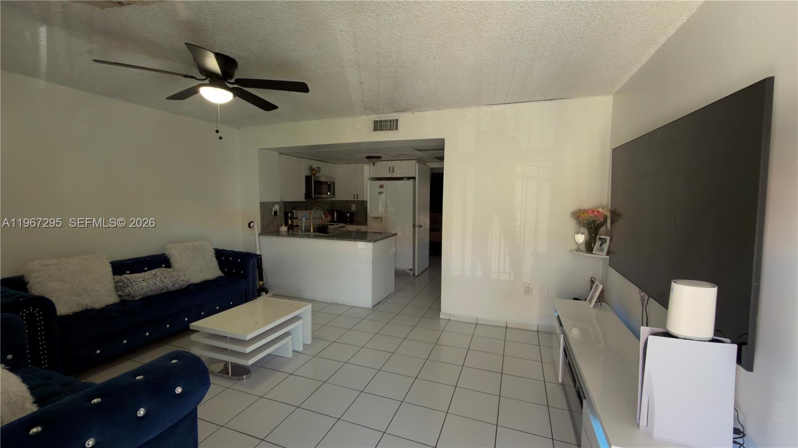 2170 West 60th Street, Unit 16205 Hialeah, FL 33016 - Photo 2 of 6 a living room with furniture and a flat screen tv